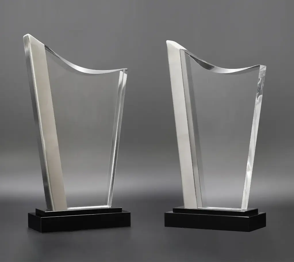 The Transparis trophy features a sleek, clear front crystal body framed by metallic rock grey sides that add a modern touch. with a glossy black base,  enhances its contemporary look, Great for achievements.