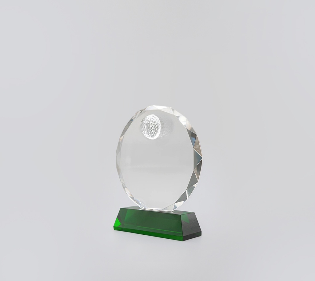 The Emerring trophy features a circular crystal frame with added crystal golf patterned ball on top center, resting on a vibrant green base. Perfect for highlighting exceptional achievements.