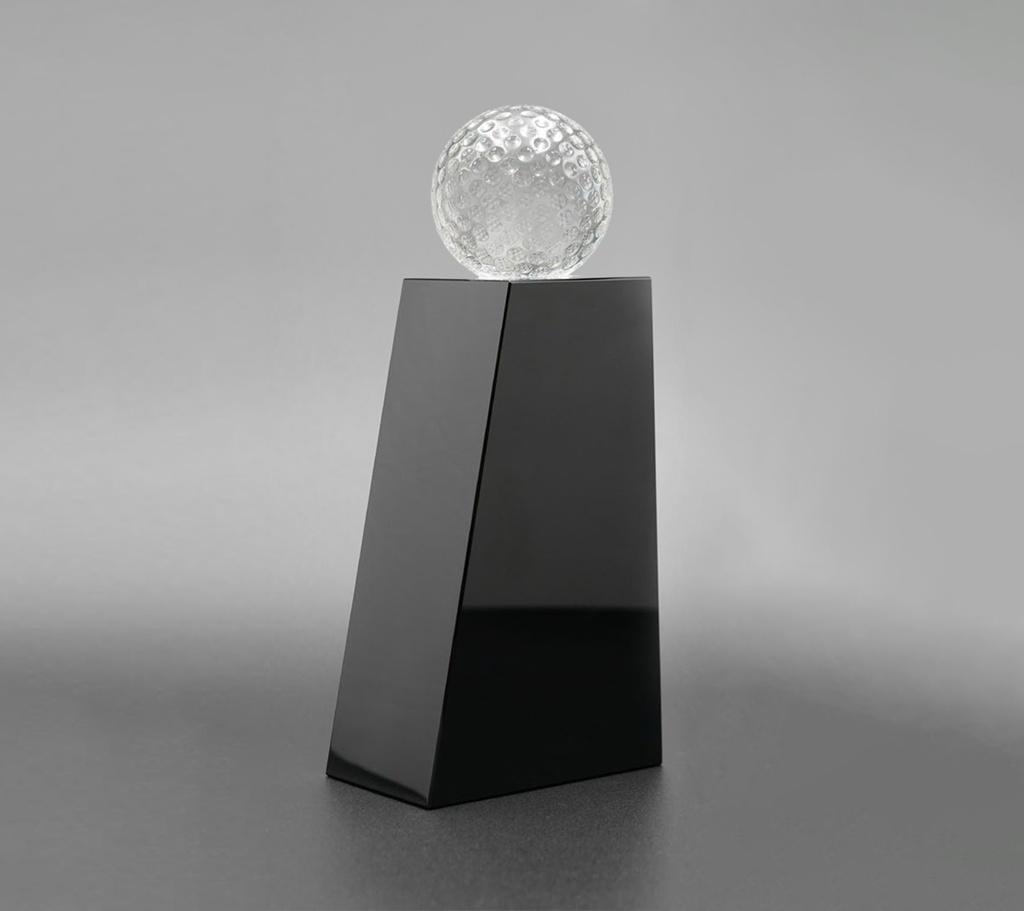 The Glaciera trophy features a glossy, angled black base topped with a patterned crystal ball. The contrast between the polished black surface and the textured ball creates a perfect look. perfect for honoring golf achievements or awards.