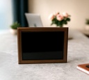 The Timberlay plaque features a sleek black panel framed by rich, dark wood, offering a timeless and professional appearance